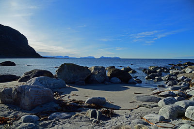 Rocks on beach against sky