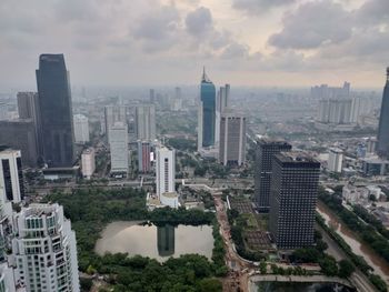 Aerial view of buildings in city against sky