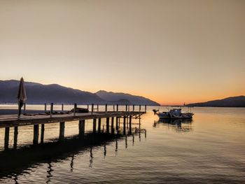 Scenic view of lake against clear sky during sunset