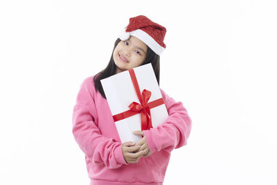 Portrait of a smiling young woman against white background