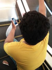 Midsection of boy using mobile phone