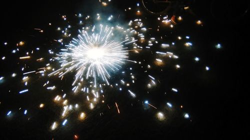 Low angle view of firework display at night