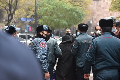 Rear view of people standing on street