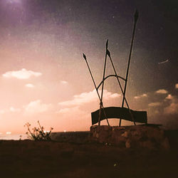 Silhouette built structure against sky at sunset