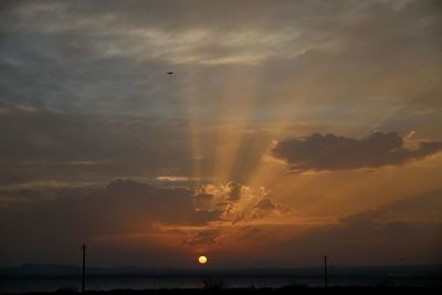 Scenic view of dramatic sky over sea during sunset