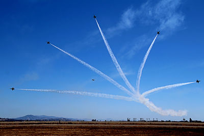 Low angle view of airshow against sky