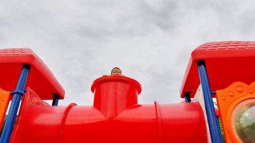 Low angle view of boy at outdoor play equipment