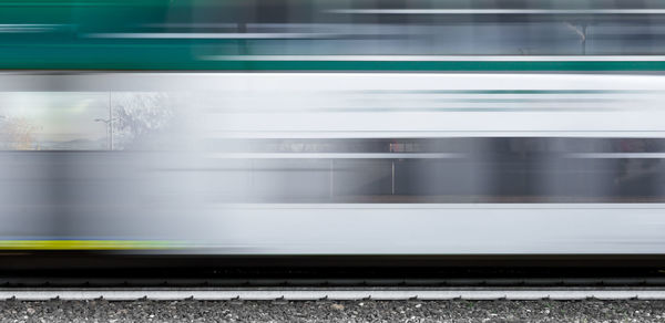 Blurred motion of train at railroad tracks