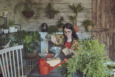 Young woman planting cactuses