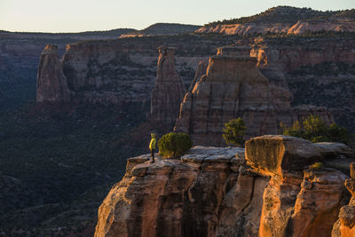 A young woman enjoys a view over colorado national monument in co.