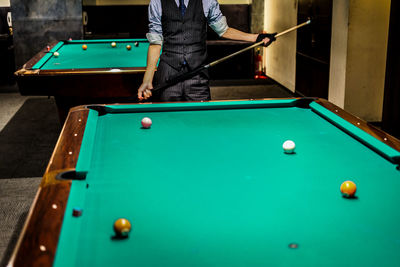 Cropped hand playing pool