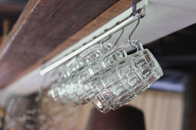 Close-up of electric lamp hanging on wood