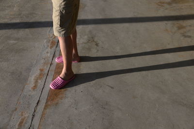 Low section of teen boy standing on ground