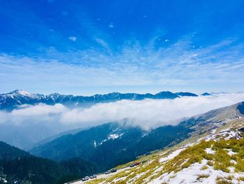 Scenic view of snowcapped mountains against blue sky