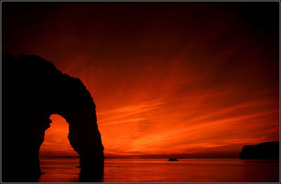 Scenic view of sea against orange sky