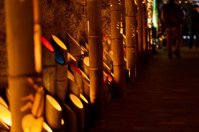 Row of illuminated temple outside building at night