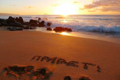 Scenic view of beach against sky during sunset