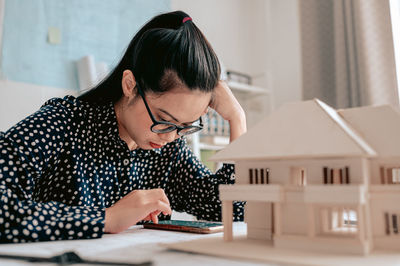 Architect making model house at home