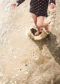 Low section of child on beach