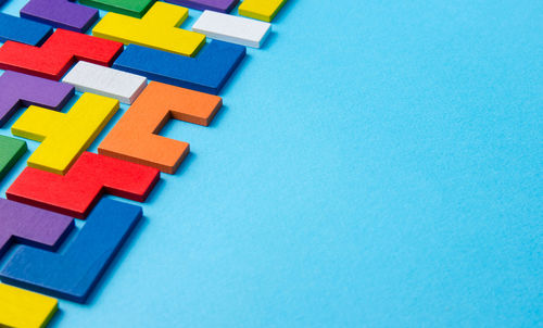 Directly above shot of multi colored toy blocks on blue background