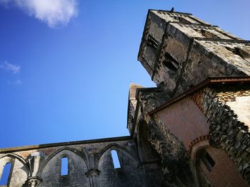 Low angle view of historic building against blue sky