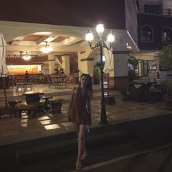 Woman walking on street at night