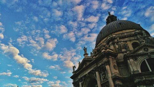 Low angle view of historical building against cloudy sky