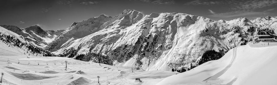 Panoramic view of snowcapped mountains against sky