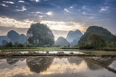 Scenic view of mountains against sky at sunset