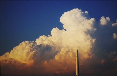 Low angle view of smoke stack against sky