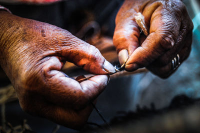 Cropped hands of woman holding string