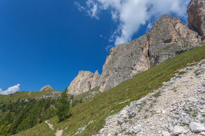 Path at the foots of the imposing southern face of mount settsass, dolomites, italy