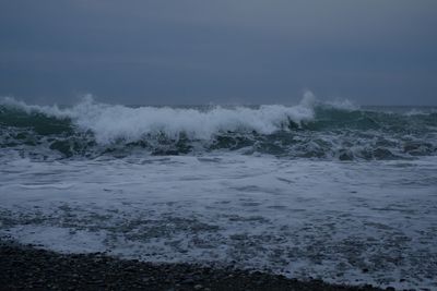 Scenic view of sea waves against sky