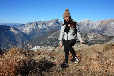 Explorer girl on adventure excursion in mountain of tuscan-emilian apennines. apuan alps on cold day
