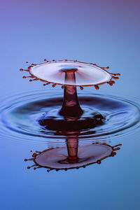 Close-up of water splashing against blue sky