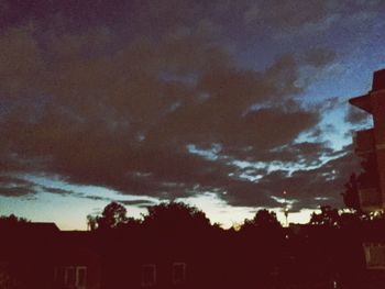 Low angle view of silhouette trees against sky at sunset