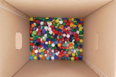 High angle view of multi colored balloons in box