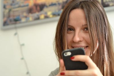 Close-up of girl using mobile phone