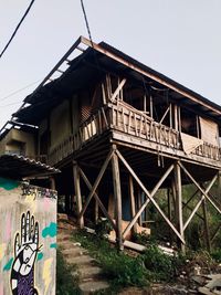 Low angle view of graffiti on bridge against sky