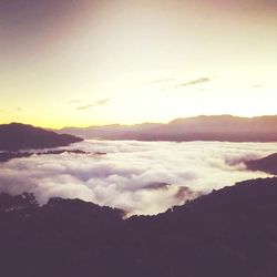 Scenic view of mountains against sky at sunset