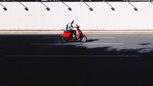 Man cycling on motorcycle against sky