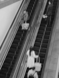 High angle view of people walking on escalator