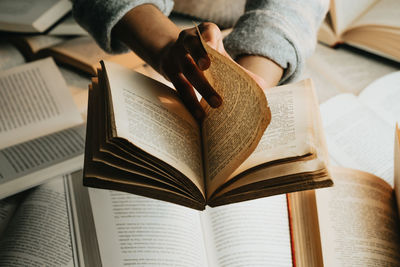 Midsection of man reading book