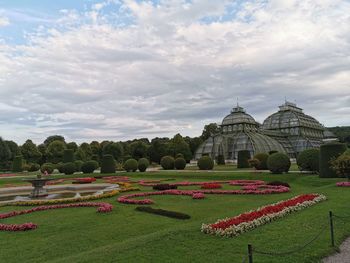 Scenic view of garden against cloudy sky