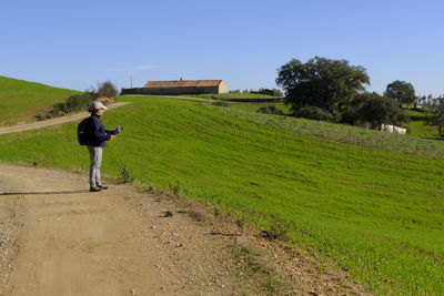 Full length of man on field against clear sky