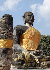 Low angle view of statue against temple building