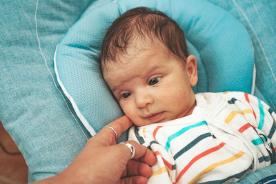 Cute baby girl on bed at home