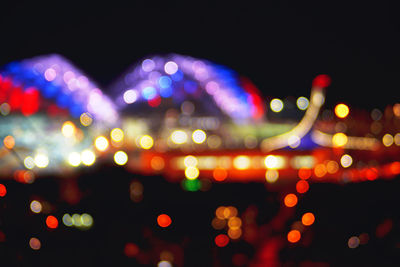 Defocused image of illuminated city at night