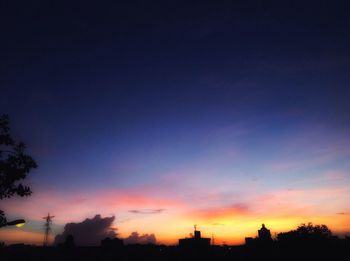 Low angle view of silhouette trees against sky at sunset