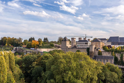 Panoramic view of trees and buildings against sky